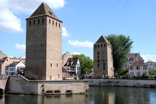 View on the towers and bridges of the Ponts Couverts (Covered Bridges) that cross the four river channels of the River Ill flowing through Strasbourg's historic Petite France quarter.  © Maria