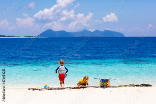 Fototapeta Naklejka Na Ścianę i Meble -  Kids playing on beach. Children play at sea.