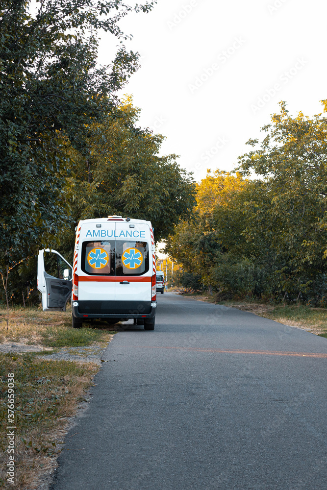 An ambulance car is parked on the side of the road. Home call An ambulance car is parked on the side of the road. Home call