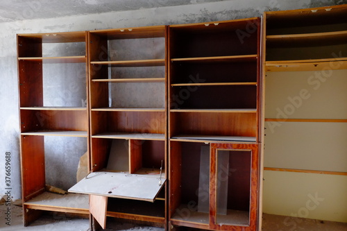 Broken wooden cabinets in an abandoned room. Old Soviet furniture in an abandoned apartment in Pripyat. © Oleksii