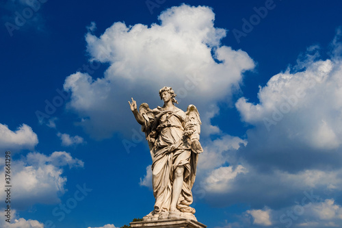 Angel statue holding the Nails of Jesus Cross among clouds. A 17th century baroque masterpiece at the top of Sant'Angelo Bridge in the center of Rome