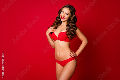Portrait photo of amazing attractive chic charming lovable slender cheerful wavy haired girl posing not hiding plastic surgery operation reesults isolated shine vibrant red color background