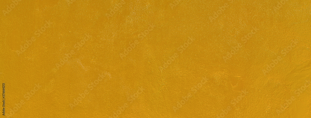 Gold texture background. Concrete wall texture paint, gold color surface blank for design Gold texture background. Concrete wall texture paint, gold color surface blank for design