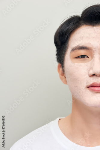 man with a mud mask on his face