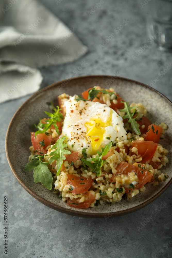 Healthy warm bulgur salad with poached egg Healthy warm bulgur salad with poached egg