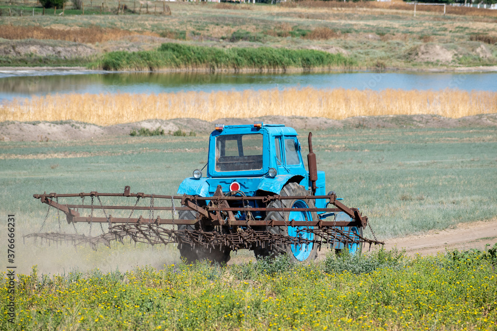 Fototapeta premium Old tractor with harrow