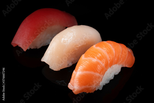 Set of various classic nigiri sushi isolated on black background