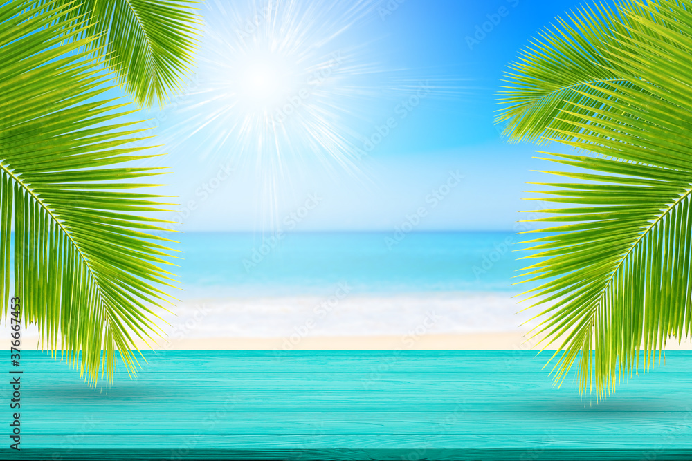 Summer Vacation Concept : Blue wooden table top with Blurred image of Tropical beautiful seascape view of blue sea and sky in background.