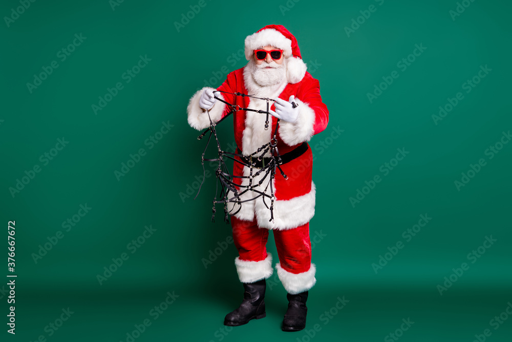Φωτογραφία Full length body size view of his he nice fat focused bearded Santa holding in h