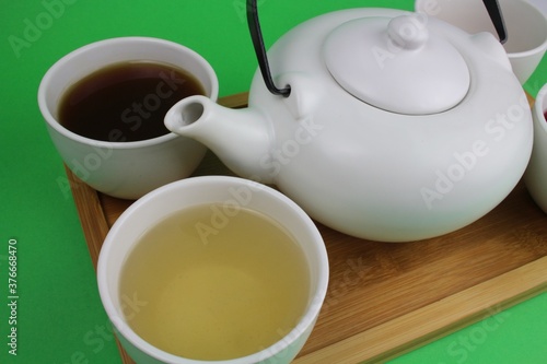 japanische Teekanne mit kleinen weißen Teetassen und unterschiedlichen Teesorten 