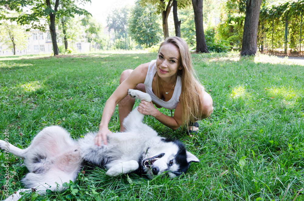 attractive blonde plays with her dog in the park. attractive blonde plays with her dog in the park.