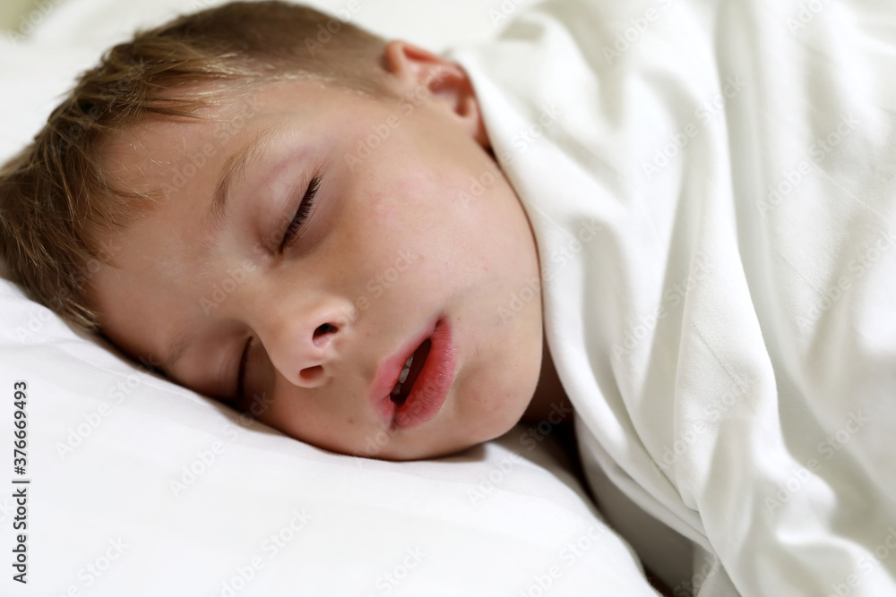 Child sleeping on bed