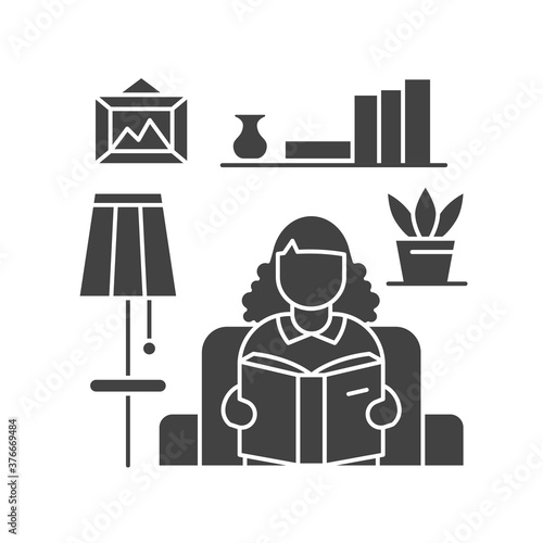 Faceless girl sitting on armchair and reading book black glyph icon. Home interior. Indoor view of living room with elements decor.