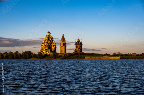 old nordic wooden buildings with domes on the island at sunset