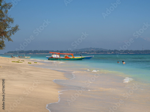 Paradise beach in blue tones with turquoise water, with  a boat on the shore © Cruzcaba