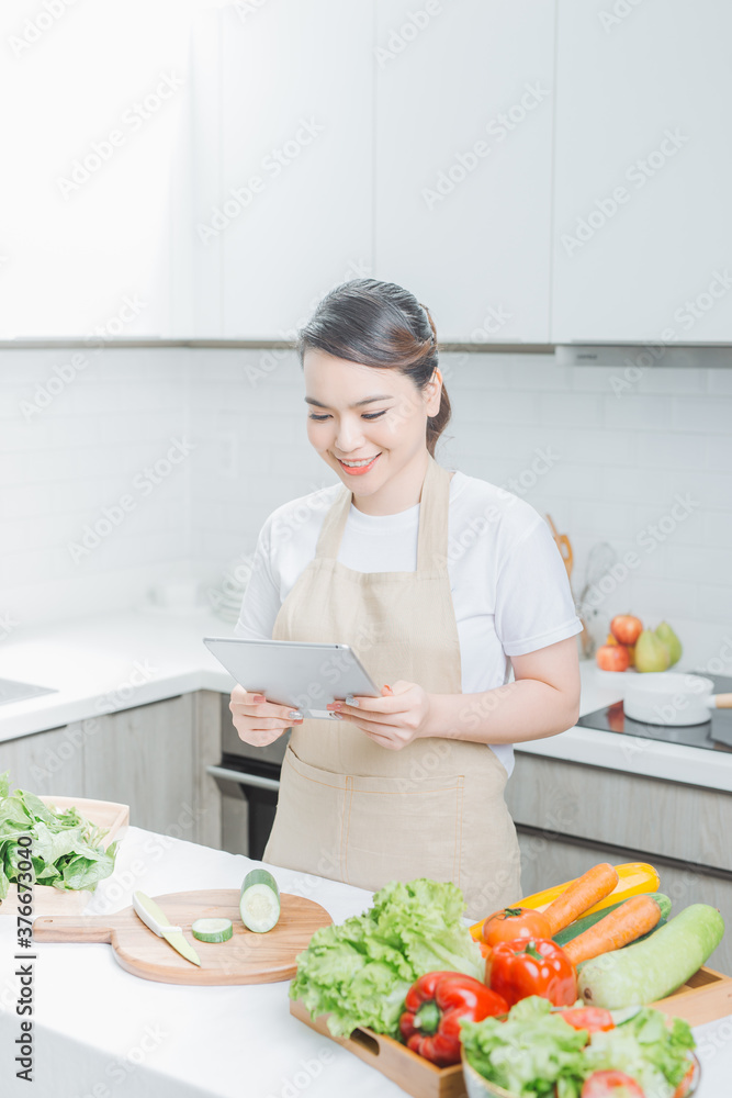 elegant housewife found new recipe for cooking in kitchen elegant housewife found new recipe for cooking in kitchen