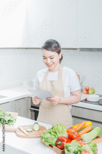 elegant housewife found new recipe for cooking in kitchen