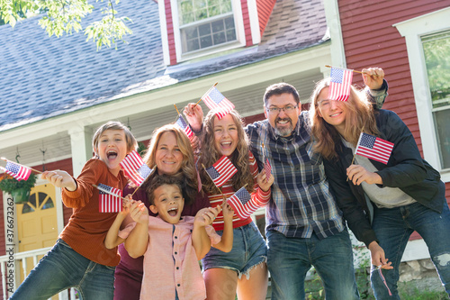 фотографія All American Family Celebrating Waving USA Flags