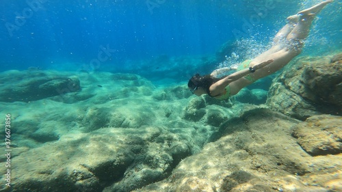 young woman snorkelling in costa brava