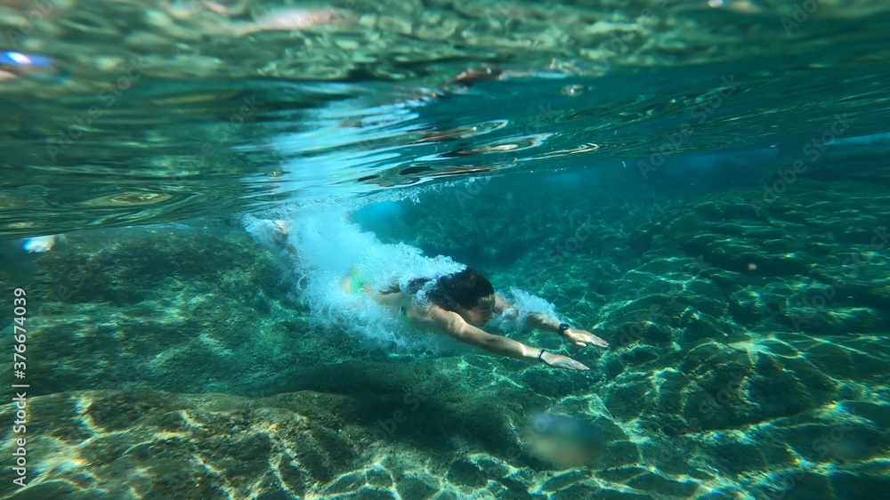 young woman snorkelling in costa brava