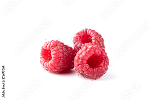 Three ripe raspberry fruits isolated on white background