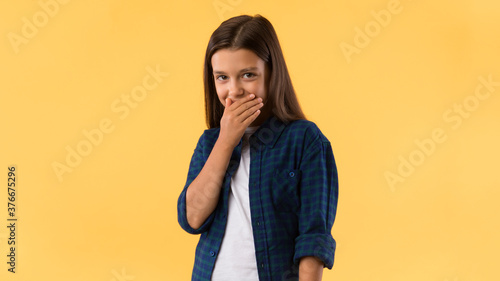 Beautiful girl laughing covering mouth with hand © Prostock-studio