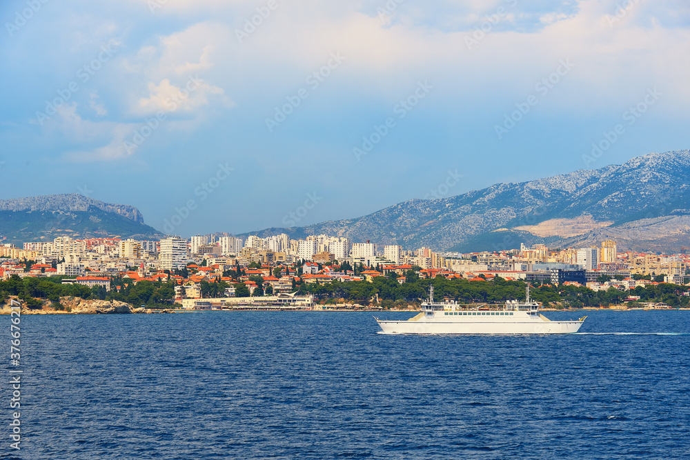 Split City Harbor from upper deck of large sea ferry boat. Sea, passenger ship, city skyline with mountains.