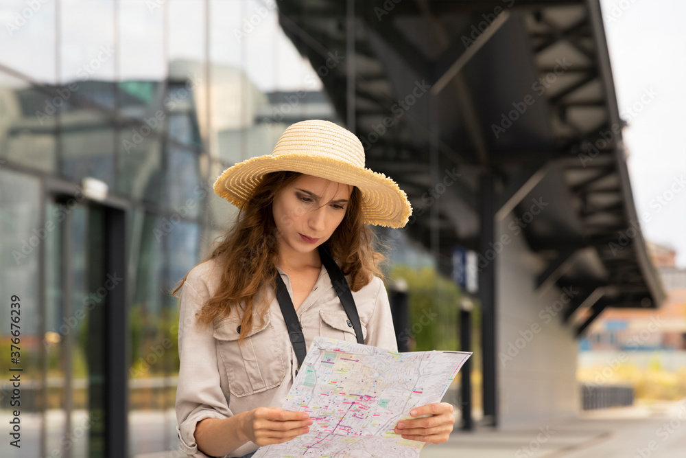A female carefully studies the map of the city.