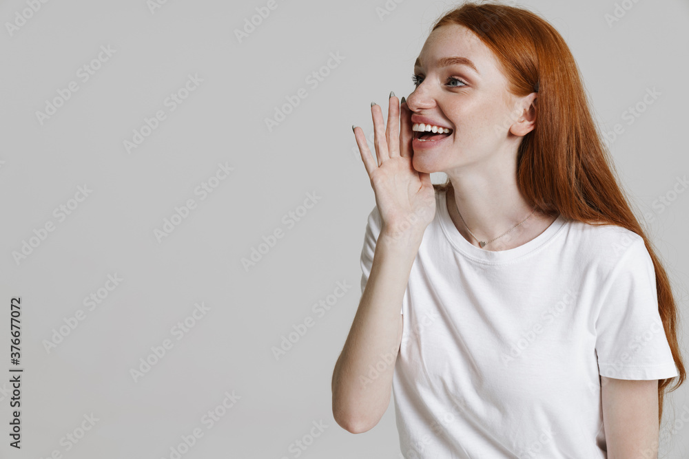 Image of cheerful ginger beautiful girl screaming aside Image of cheerful ginger beautiful girl screaming aside