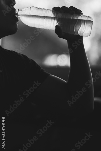 Young Man Drinking Water At Gym