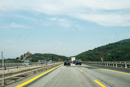 The car traffic on the modern highway crossing the border between Spain and France