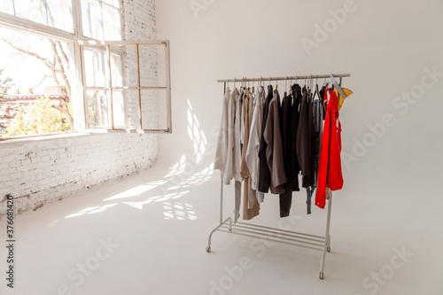 A choice of clothes on a rack. Wardrobe rack with stylish clothes