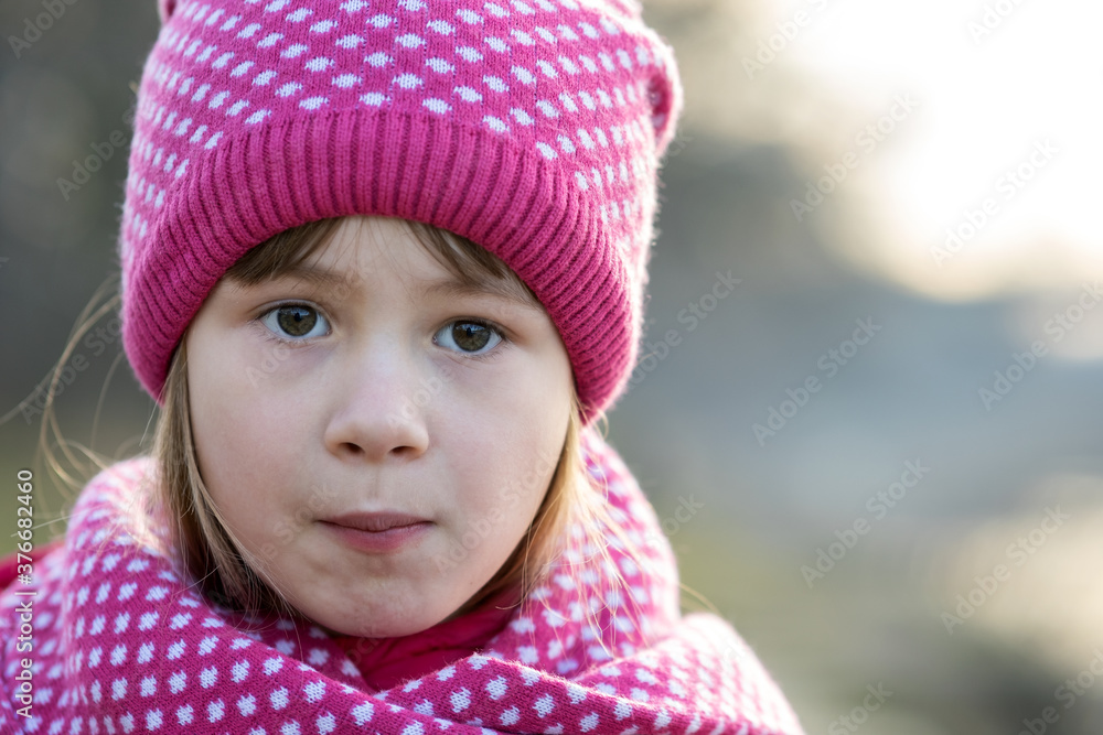 Pretty child girl in warm knitted winter clothes outdoors. Pretty child girl in warm knitted winter clothes outdoors.