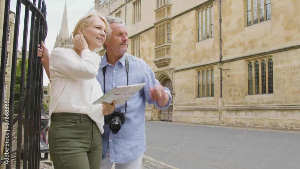 Medium Panning Shot of Middle Aged Couple Reading a Map Medium Panning Shot of Middle Aged Couple Reading a Map