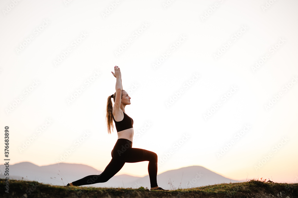 Woman balanced, practicing meditation, zen energy yoga in mountains. Healthy lifestyle concept. Young girl doing fitness exercise sport outdoors. Morning sunrise. Relax in nature.