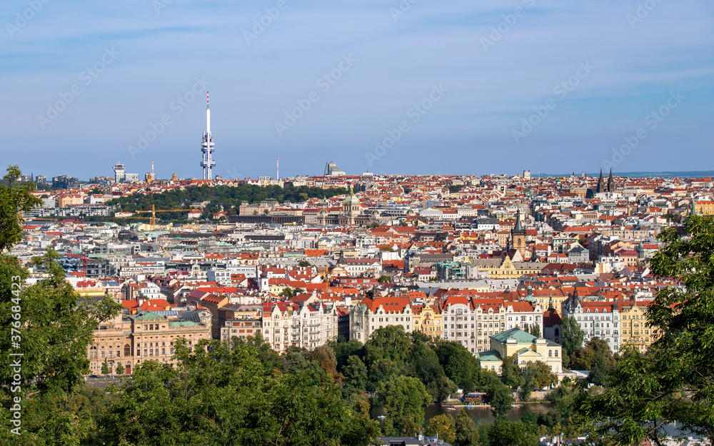 View of evening Prague from Petrin Hill. Picturesque red roofs and many towers