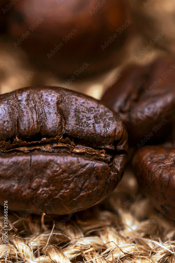 Coffee beans. Macro photo Burlap fabric. Rough fabric texture. Fabric Canvas. Coffee beans on sacking. Coffee abstraction. Coffee beans. Macro photo Burlap fabric. Rough fabric texture. Fabric Canvas. Coffee beans on sacking. Coffee abstraction.