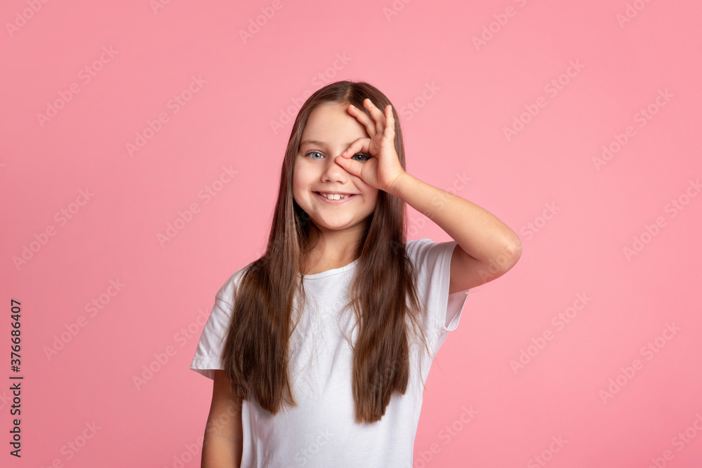 Everything is cool. Smiling kid doing ok sign with hand on eye looking through fingers Everything is cool. Smiling kid doing ok sign with hand on eye looking through fingers
