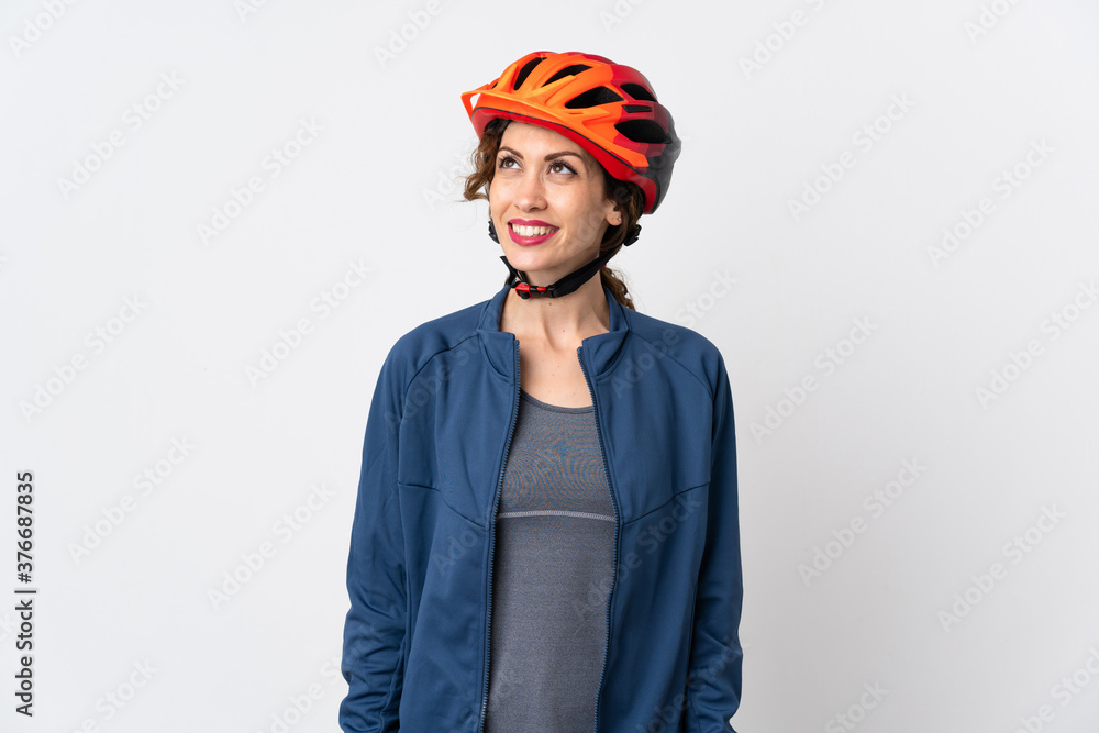 Young cyclist woman isolated on white background thinking an idea while looking up Young cyclist woman isolated on white background thinking an idea while looking up
