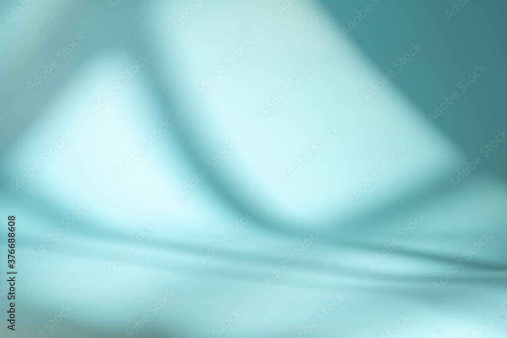 Blue space with light and shadow from the window - background for product presentation Blue space with light and shadow from the window - background for product presentation