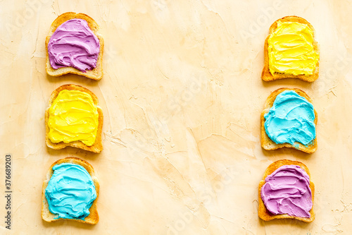 Unicorn colored toast bread slices. Food background, top view