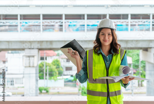 Female Civil engineer is working on tranportation development in the background. photo