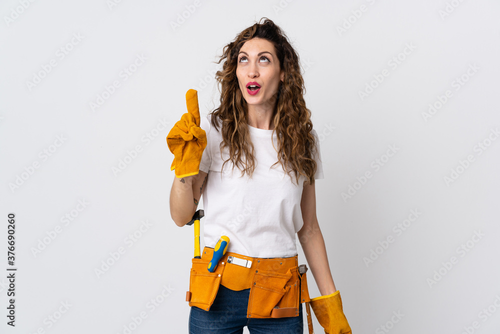 Young electrician man isolated on white background intending to realizes the solution while lifting a finger up Young electrician man isolated on white background intending to realizes the solution while lifting a finger up