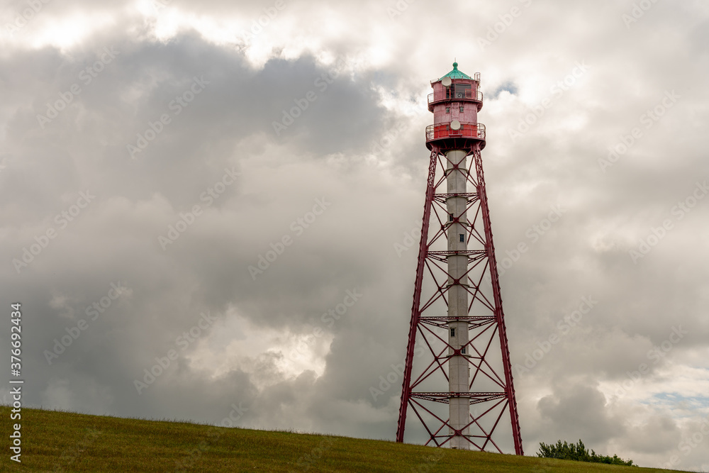 view on the lighthouse of campen near emden, north sea, germany