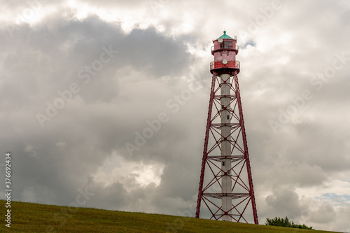 view on the lighthouse of campen near emden, north sea, germany