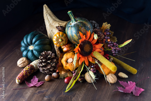 Close up of a cornucopia centrepiece filled with various autumn decorations photo