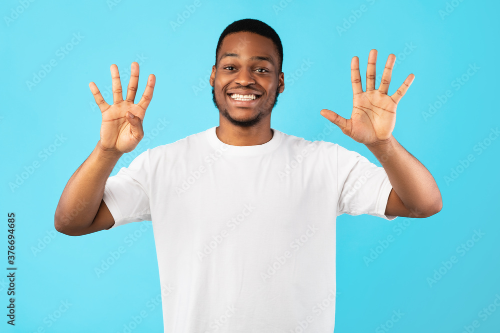 African Man Counting Showing Number Nine Standing In Studio African Man Counting Showing Number Nine Standing In Studio