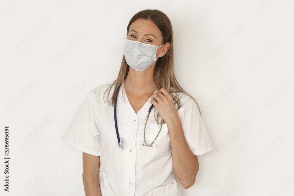 Portrait of nurse wearing face mask, standing on white background -isolated