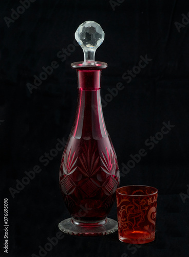 red glass bottle with glass