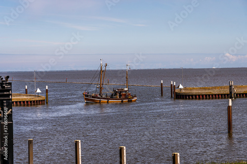 fishing boats returning from their tour to bernersiel, north sea photo